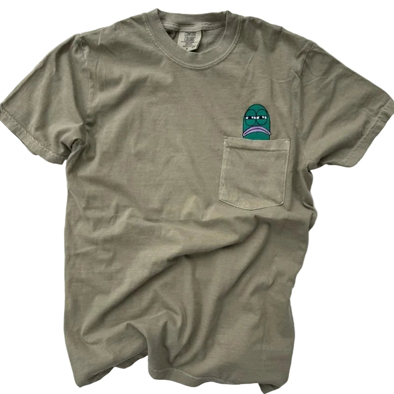 Green t-shirt with a teal fish embroidered ticking out of the shirt pocket on the left side.